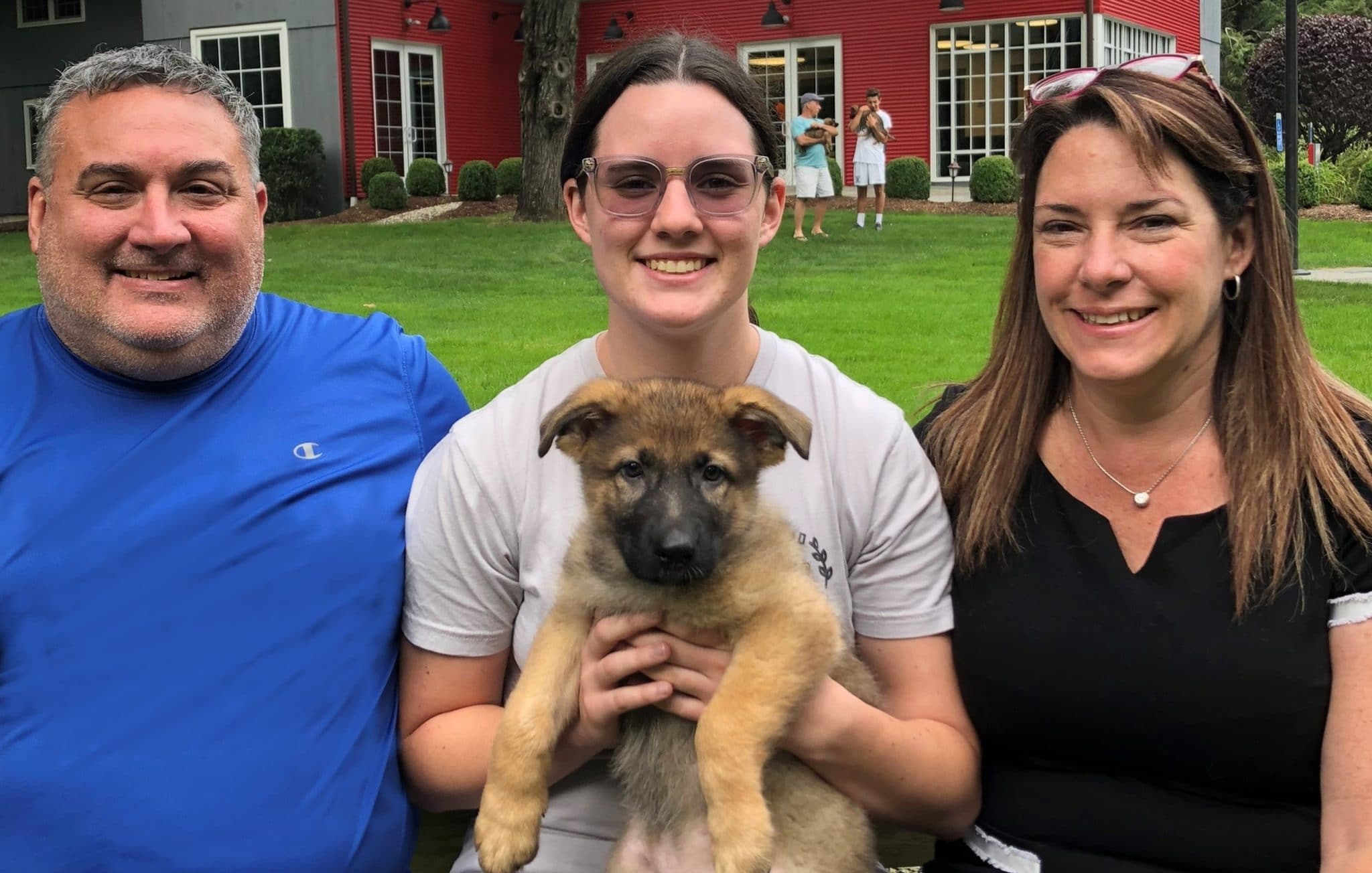 The Chapman's, a volunteer puppy raiser family, with Fidelco pup, "Lincoln".