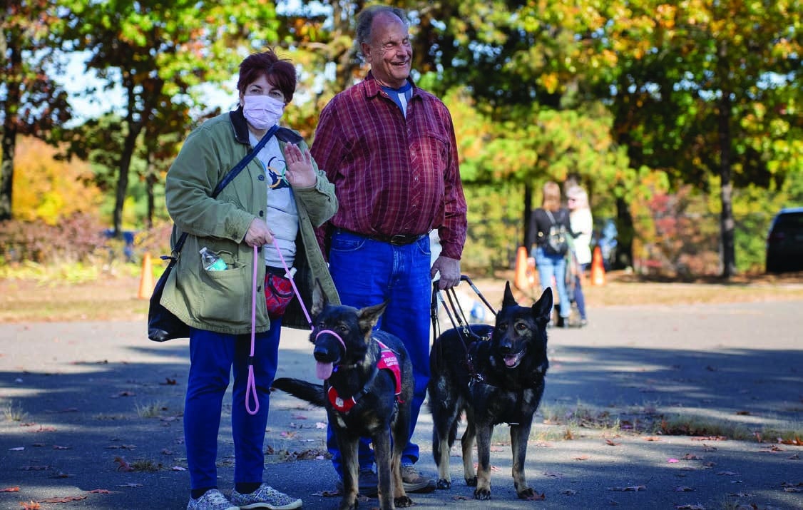 Gerry walking with his guide Devyn and a volunteer puppy raiser Nancy Handley at Fidelco's annual Octoberfest event.